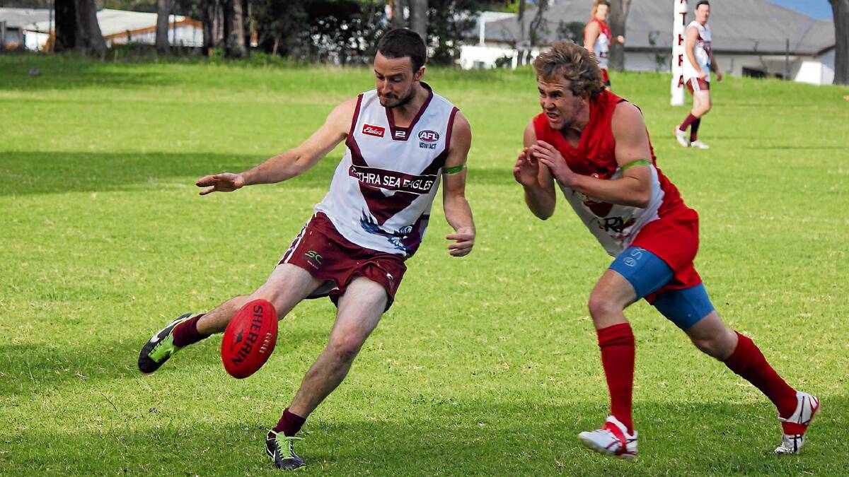 • Sea Eagle Ryan O’Loghlin tries to get a kick off as his Eden opponent charges him down.