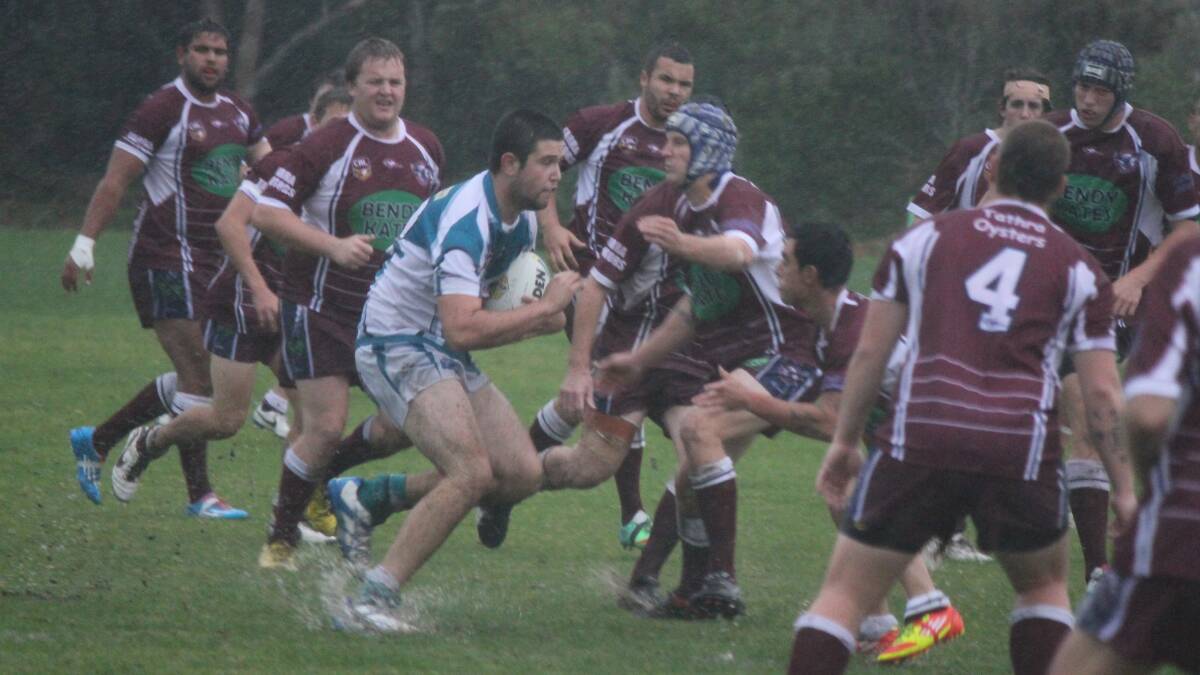 • Panther Nicholas Brown surges forward in the wet conditions, but finds himself surrounded by Sea Eagles during Sunday’s clash. 
