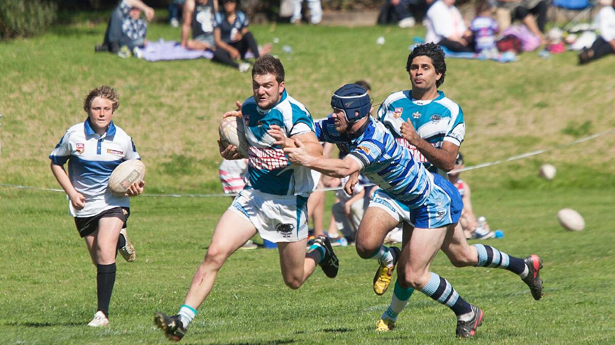 • Panther Brock Ringland runs hard down the right wing as Moruya’s Ray Turner closes in during Sunday’s preliminary final clash. 
