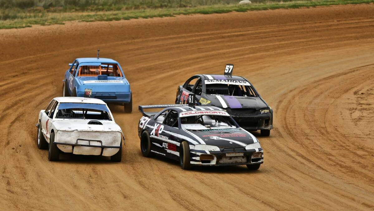 • Cars slide through the corner with rainy conditions at the Sapphire Speedway on Saturday.