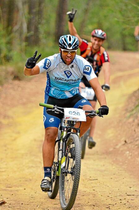 • Ryan Thew throws up the peace sign during last year’s Tathra MTB Enduro.
