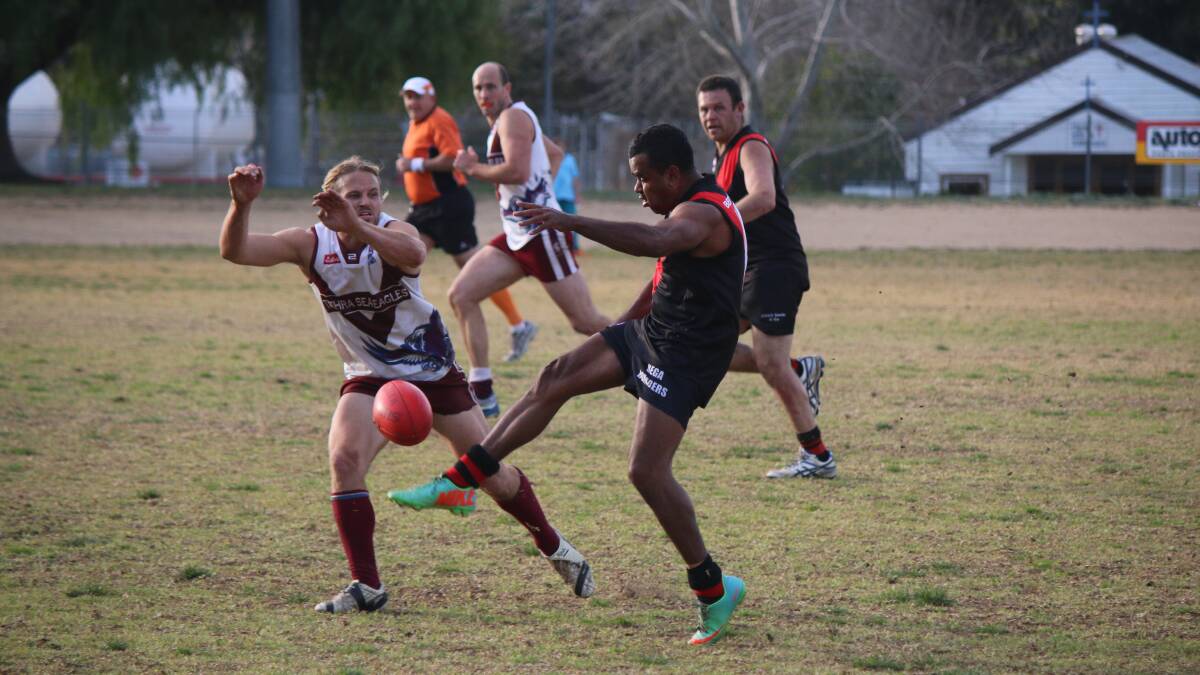 • Tathra’s Shayne Rettke lunges to block a kick by Bomber Steven Luff when the Sea Eagles last met Bega recently. 