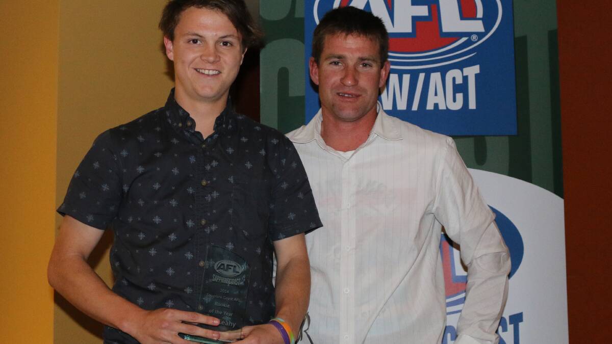 • Bega Bomber Dale Leahy is presented the SCAFL Rookie of the Year award by Pambula captain Sean Smith.