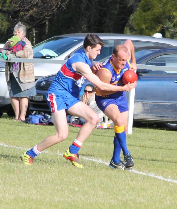 • Bermagui’s Brendan Matters tries to handball with Digger Nick Marshall edging him to the sideline.