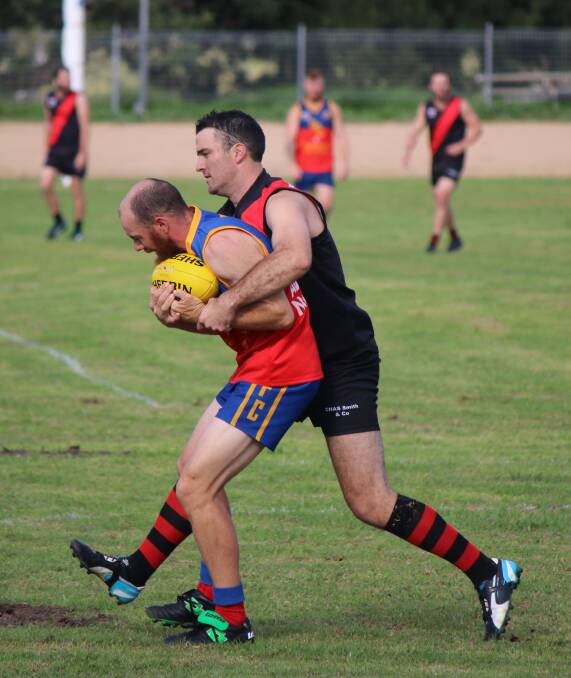 • Bega Bomber Adam Blacka lays a tackle on his Narooma opponent on Saturday at the Bega Showground. 