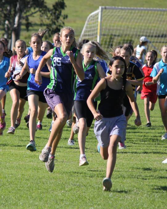 • Tarni Evans (left) and Ava Strang keep pace during the 12/13 years girls cross country on Friday. 