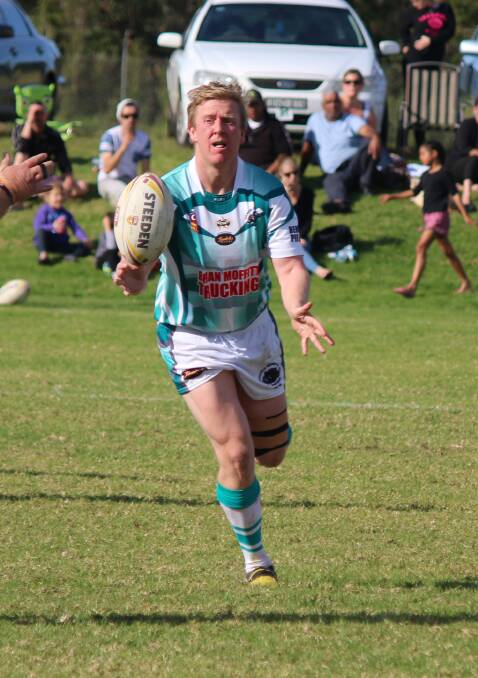 • Panther Jamie Glenn offloads against the Eden Tigers last week. Glenn will form one of the strong ruck workers for Candelo-Bemboka against Bega. 