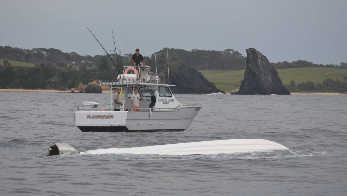SALVAGE MISSION: The two Charter Fish Narooma boats Nitro and Playstation came to the rescue on Thursday recovering the upturned fishing boat that flipped on the Narooma bar crossing on Wednesday. Photo by Stan Gorton 
