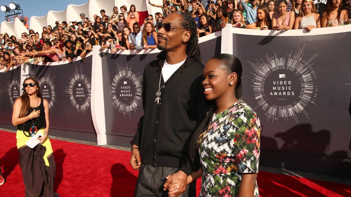 Recording artist Snoop Dogg and Cori Broadus attend the 2014 MTV Video Music Awards. PHOTO: Getty Images