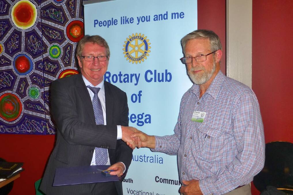 Barry Irvin (left) of Bega Cheese and Giant Steps is made a Paul Harris Fellow, one of Rotary International’s highest honours, in a presentation by Bega Rotary president Charlie Blomfield. 
