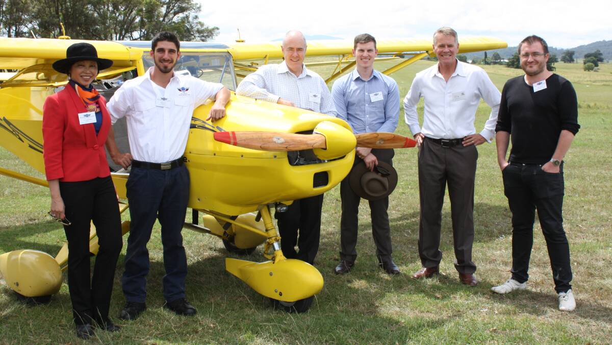 Discussing plans for a Chinese flight school at Frogs Hollow in February 2015 are former Deputy Premier Andrew Stoner (second from right) and company directors of Sports Aviation Australia (from left) Caroline Hong, Mitch Boyle, Jason Parker, Jason Ryan and Brad Stebbing.