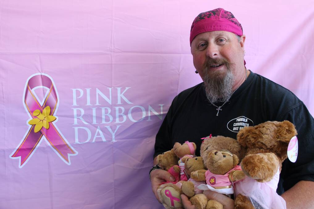 Glenn Cotter displays some of the Pink Ribbon Day merchandise. 
