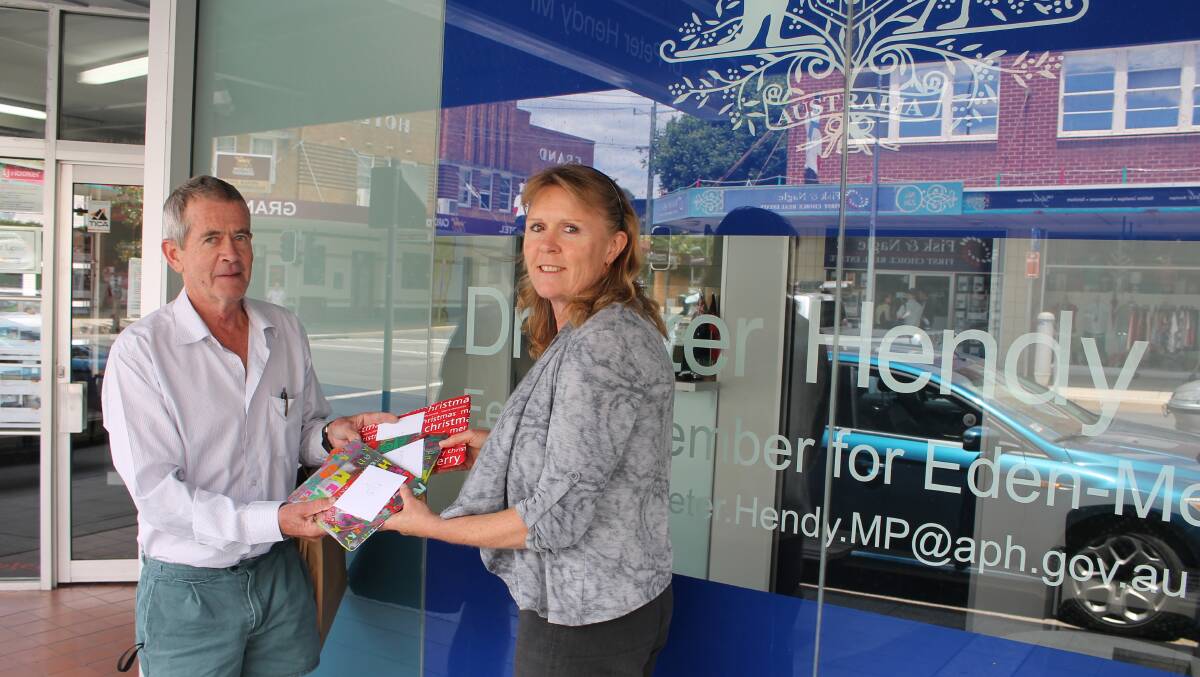 Andrew McPherson gives presents of calculators to Peter Hendy’s Bega electorate officer Kristi Fristad. 