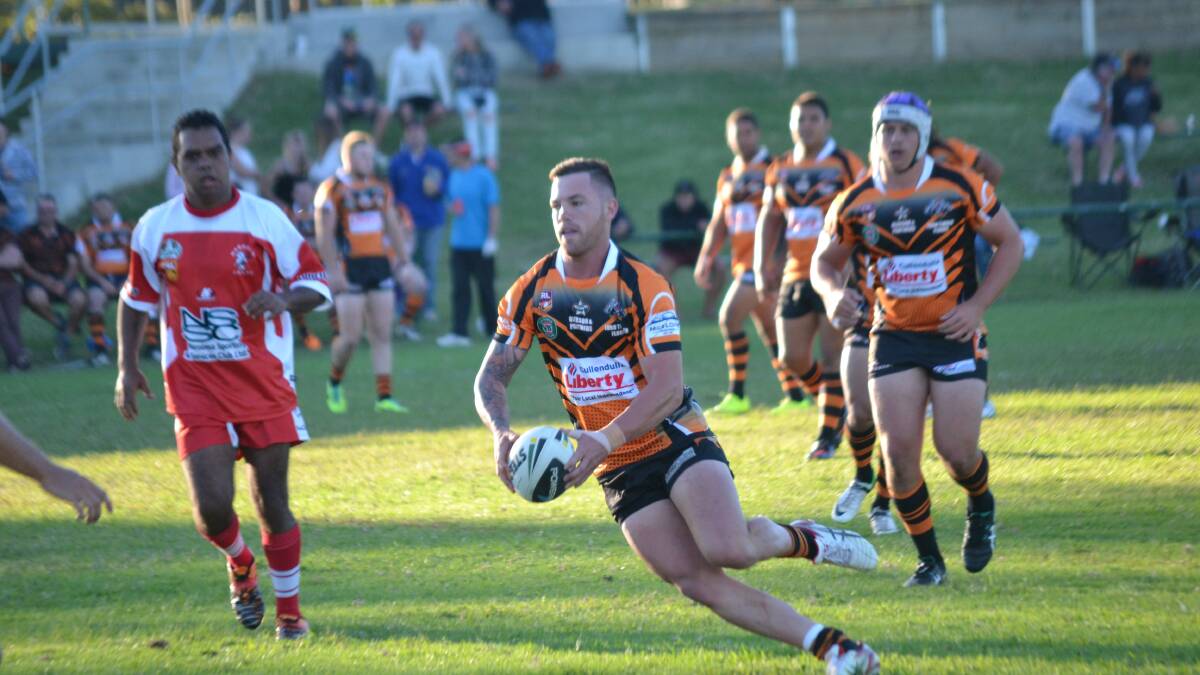HIT-UP: Kane Leggett takes a run against Narooma during the first half on Saturday. 