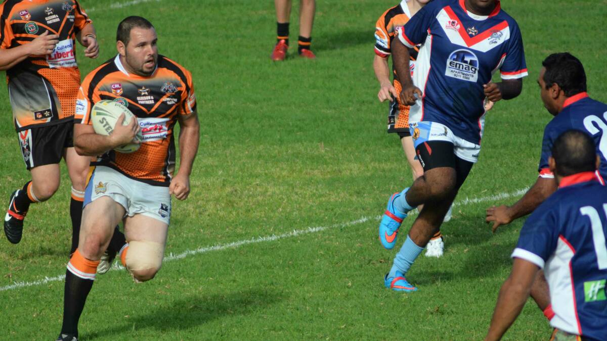  TIGER TOUGH: Billy Zahra runs the ball from his half against the Group 16 Indigenous Dream Team at Mackay Park.
