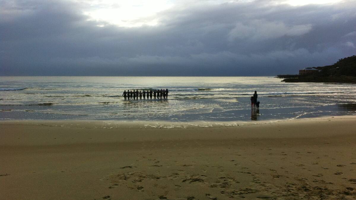 Morning swimmers at Tathra paid tribute to their lost friend, Chris Armstrong, by walking back into the water, arm in arm.
