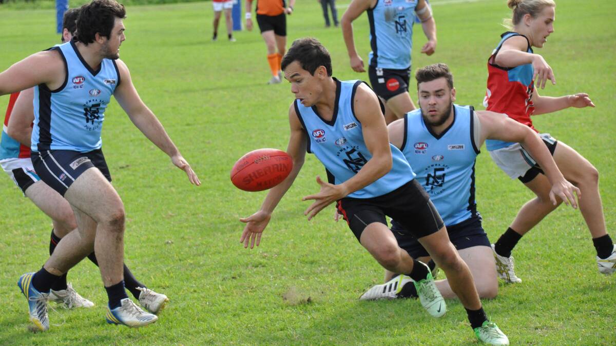 NOWRA: Nowra Blues player Kenny Dan scrambles for the ball as his team struggles to gain a lead over Kiama Power. Photo: PATRICK FAHY 