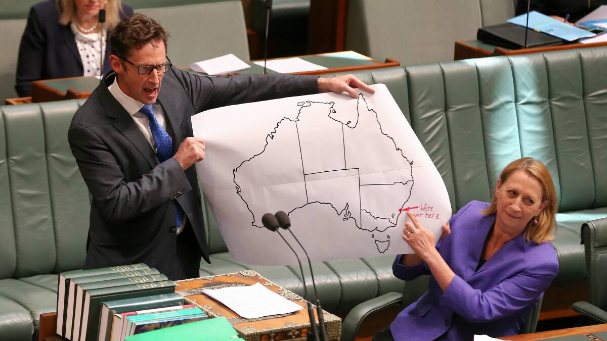 Labor MPs Stephen Jones and Sharon Bird hold a map featuring the words "we're over here" - in reference to the Illawarra's location - during a 90-second statement before Question Time on December 2 last year. Picture: Alex Ellinghausen