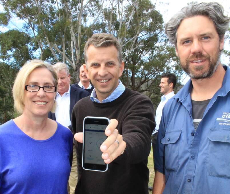 Leading the way: Andrew Constance launches the new oyster farming technology with Ros Harvey and Pambula oyster farmer Greg Carton. 