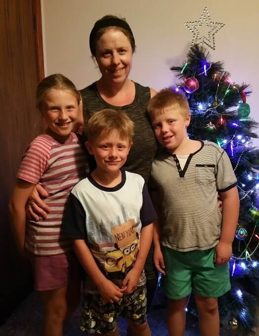 Happy family: Tracey Beasley and her three children Molly, Toby and Banjo celebrating Christmas together. Tracey does everything she can to keep her children's heads up and to encourage them to be positive in these tough times.  