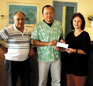Dr Terry Wong (centre) receives a cheque for $1,000 from the Bega Rotary Club for his work for Tashi Palkhiel from Rotary president, Eva Taylor, and treasurer, Dirk Kruitt, at the Bega Dental Practice.