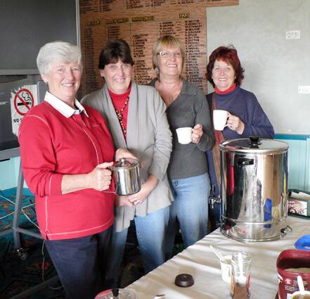 Kay Adamson (left), Carol DeJong, Christine Cowell and Chris Page team up to make a cup