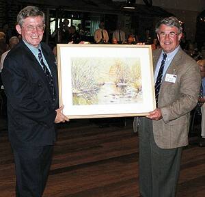 Paul Healey presents David Necker with a Lovella McPaul painting of the Bega River.