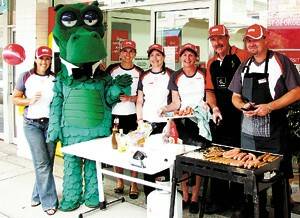 At the St George bank sausage sizzle last Wednesday were, left to right: Libby Balmain (Batemans Bay), Happy Dragon, Kate Wright, Wendy Deighton, Julie Lay (branch manager), Merv Whybrow (business banking manager) and Dave Sweet (branch lender).