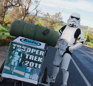 • Storm trooper Jacob French takes a well-earned breather near Bega this week, nine months into his “trek” from Perth to Sydney to raise money for the Starlight Children’s Foundation. 