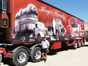 •Tony Hayes with one of the trucks showing the Hayes family’s five generations in transport.