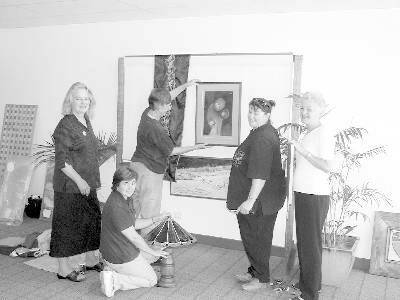 • Members of the Valley Originals Co-operative, Anna Buck, Kay Dowman, Jan Bolsius, Kaz Langenhorst and Denise Carey, set up their display for Art in the Streets in the window of Country Energy.