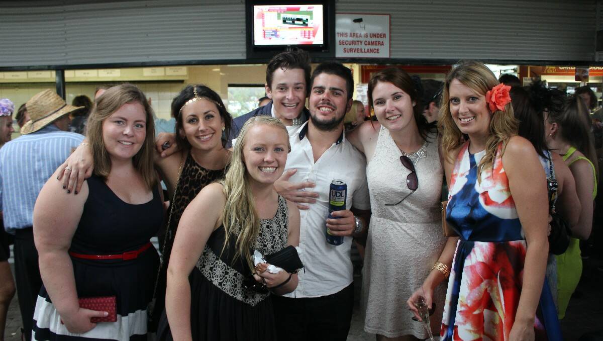 Taking shelter from the afternoon rain at the Sapphire Coast Turf Club are (from left) Hannah Green, Kaycee West, Steph Pearce, Power FM’s JoJo, Johnno Di Donato, Caitlin Johnson and Aimee Hay.