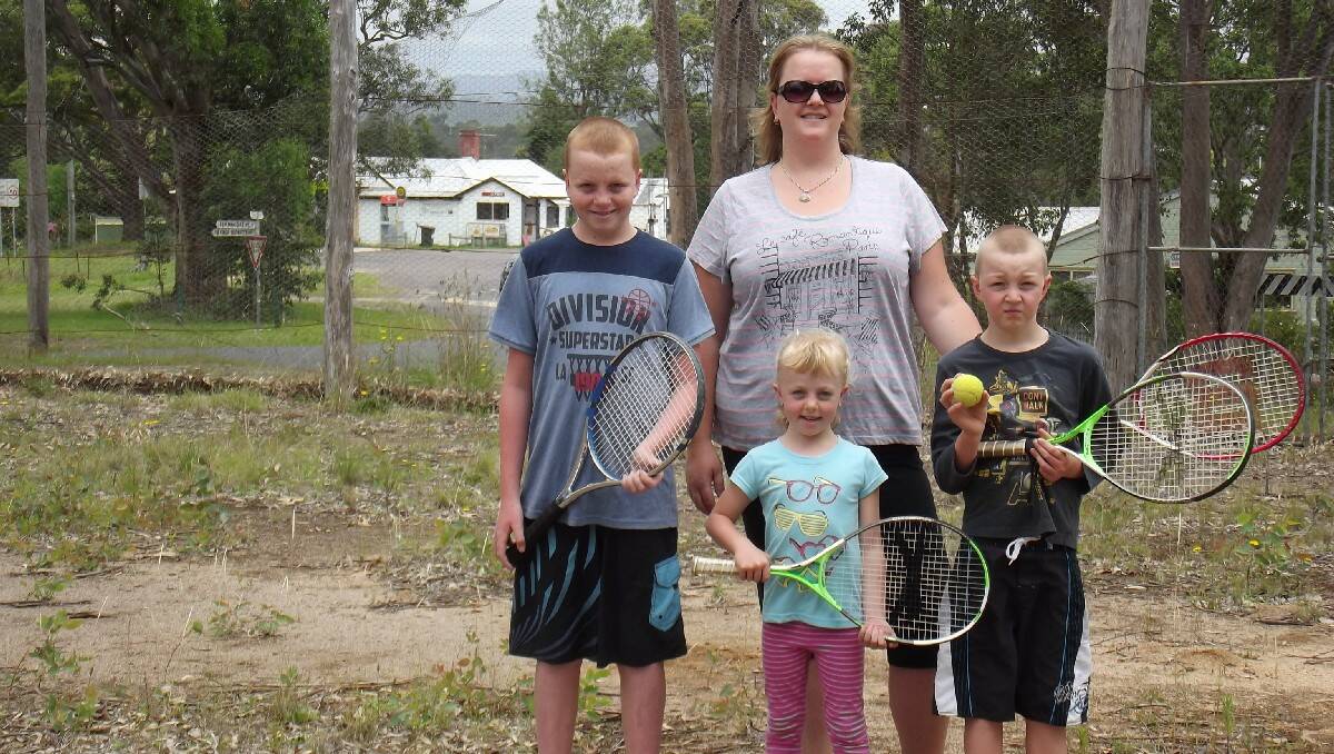 Quaama Tennis Club president Rebecca Grenfell and her children - Lachlan, Kya and Brodie - inspect the overgrown courts at Quaama the club is hoping to restore.