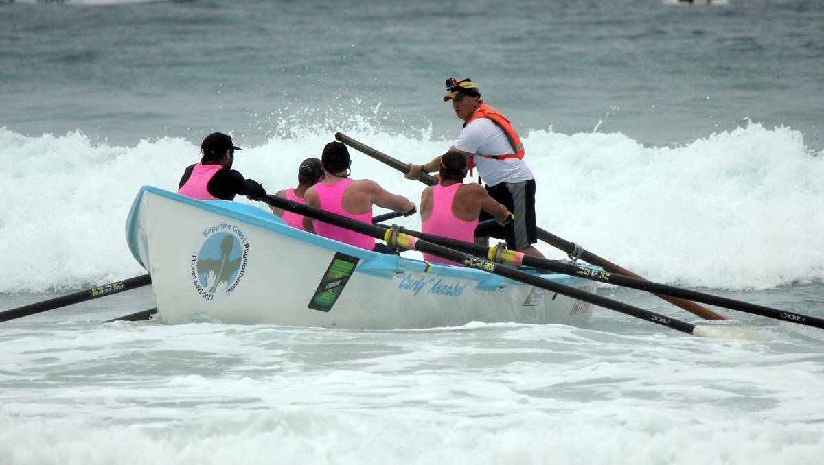 The Tathra men's veteran crew confronts a wave during Friday's George Bass Marathon leg from Tathra to Pambula Beach.