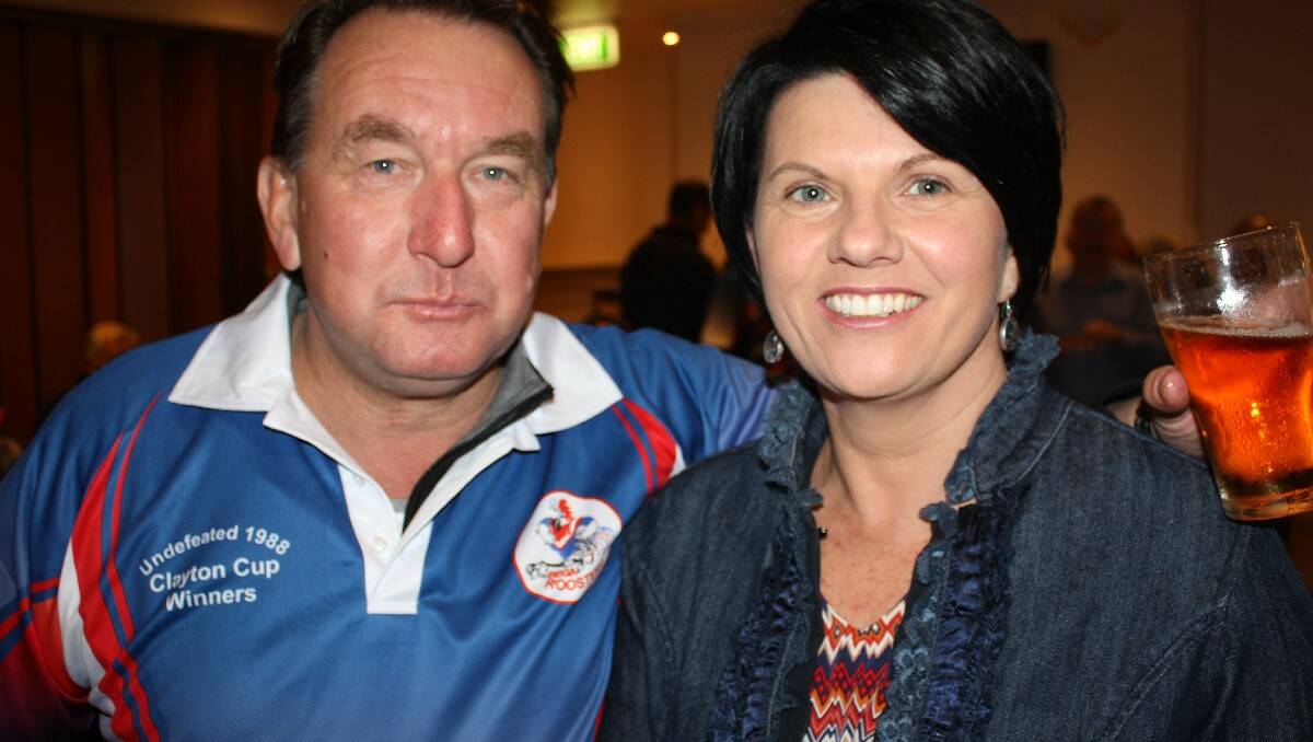 Darrell Worley chats with Julie Welsh during the Roosters reunion dinner.