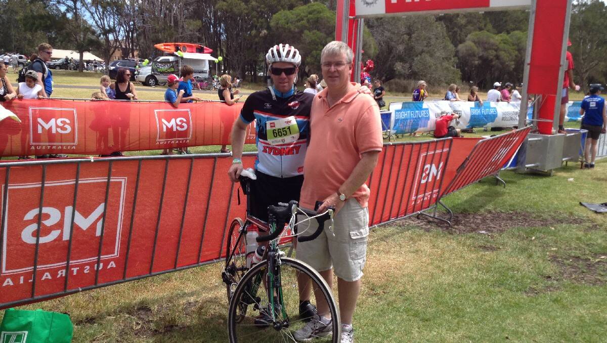 Graeme Whyman congratulates his son Dean on completion of the MS Sydney to the Gong Bike Ride last month. A team from Bega raised over $10,000 for the MS Society.