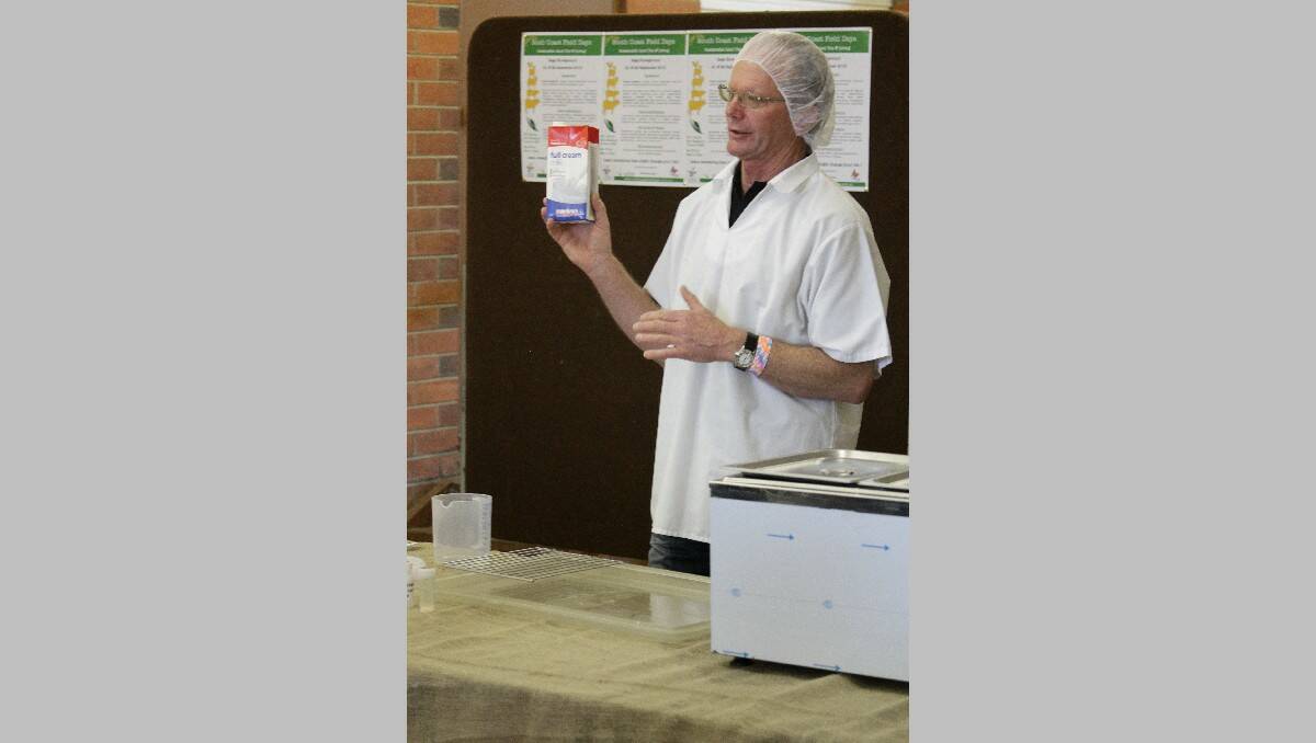 Mark Williams shows a step involving full cream milk during the camembert-making display.
