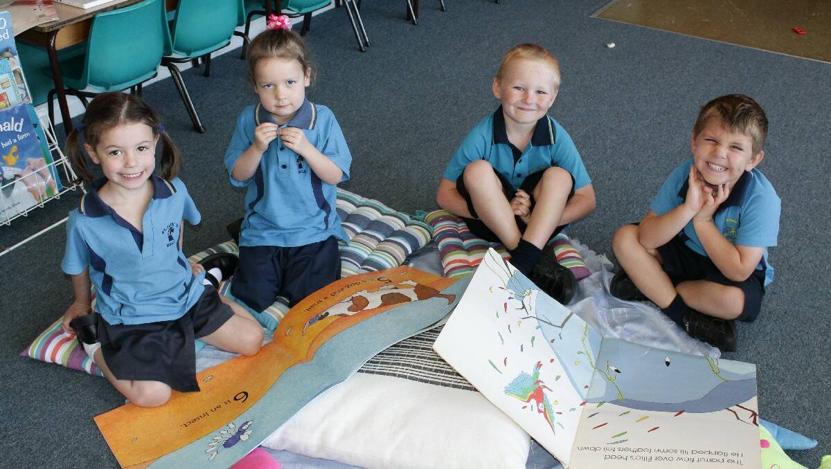 Reading their favourite books are St Patrick's Primary School Kindies (from left) Sophie Watson, Hannah Watson, Braith Edmunds and Leo Rix.