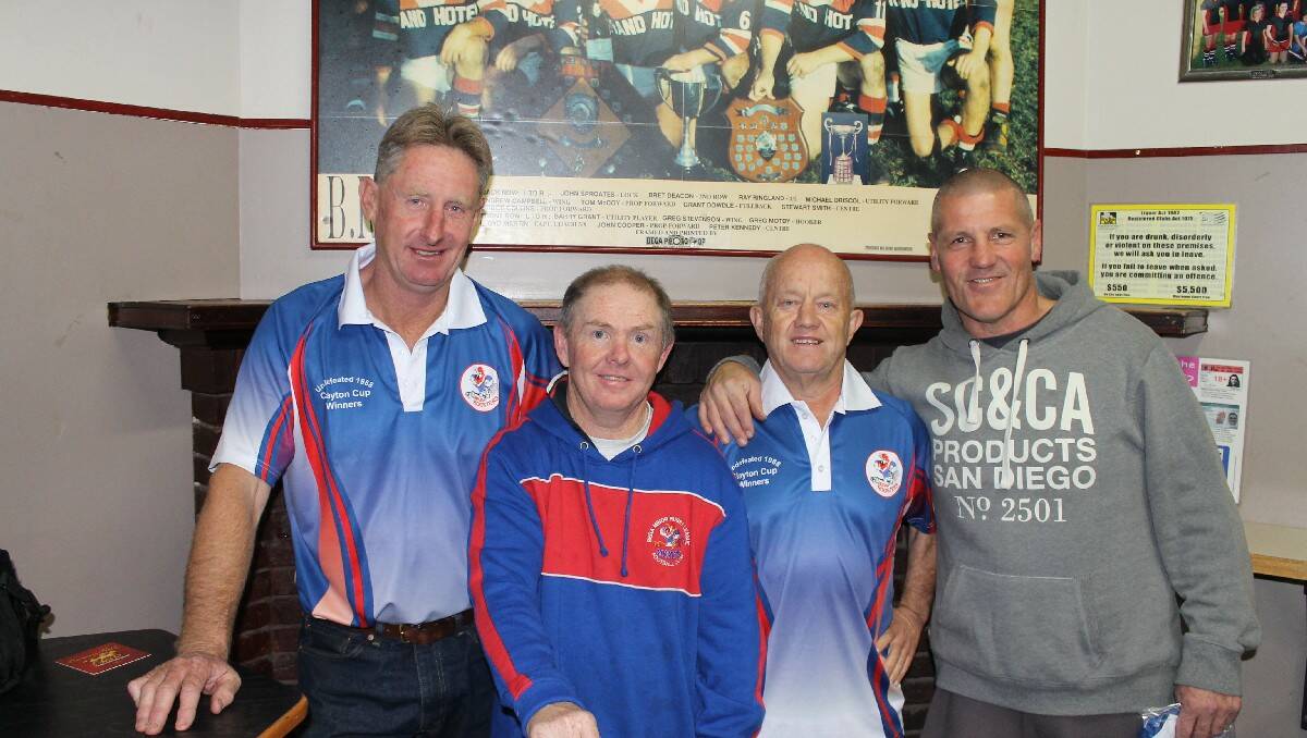 Standing under a photograph of the 1988 Bega Roosters title-winning side are (from left) Stewart Smith, Ray Ringland, life member Peter Turner and Tom McCoy.