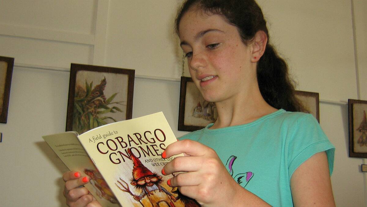 Genevieve Spicer from Sydney enjoys her copy of A Field Guide to Cobargo Gnomes, launched at Well Thumbed Books in Cobargo recently.
