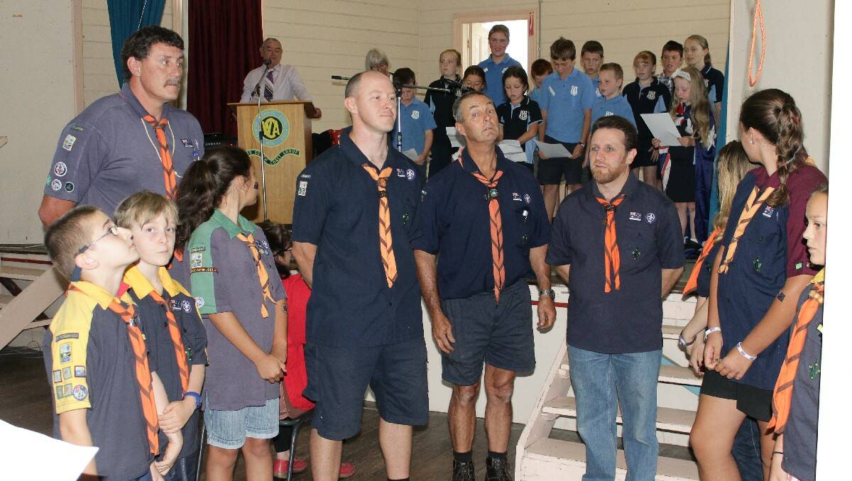 The Cobargo Scouts, including leader and Cobargo Citizen of the Year Graham Parr (fourth from right), prepare to unveil the Australian flag.