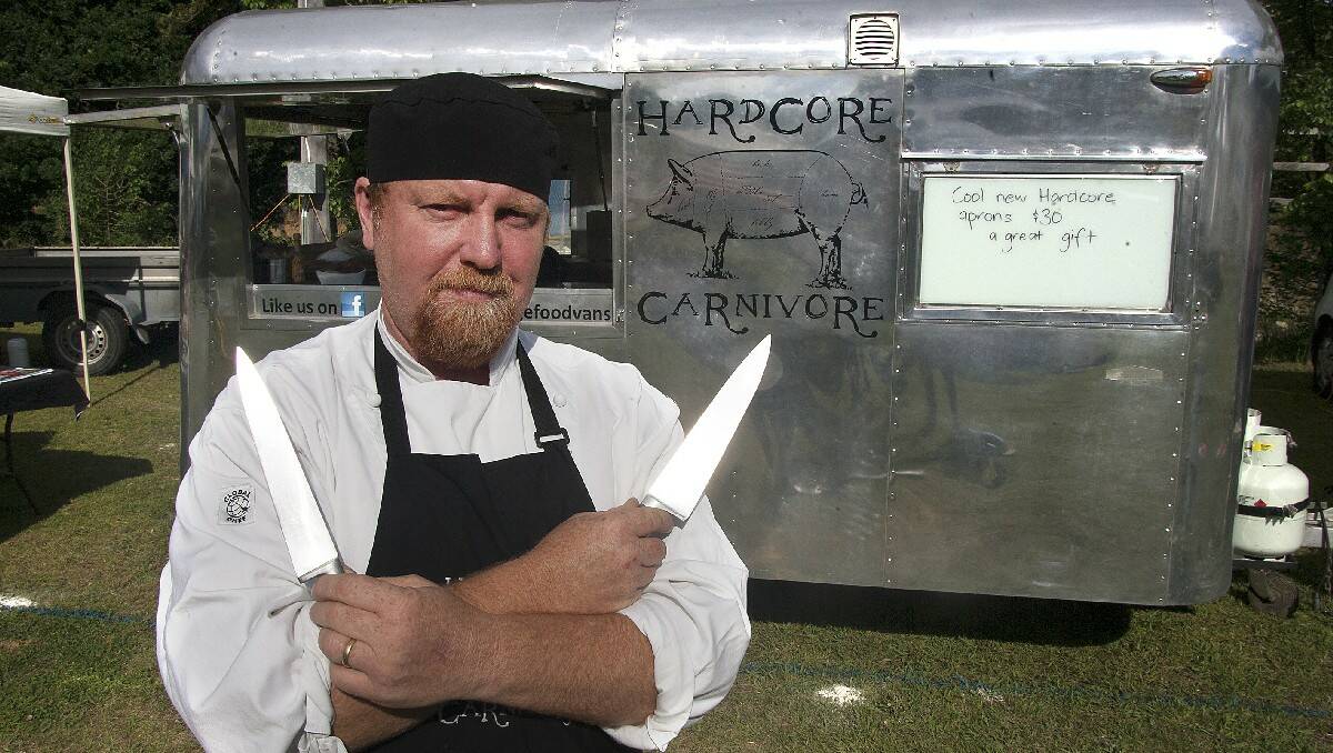 Hard-Core Carnivore chef and owner Steve Jackson stands outside his converted vintage caravan at the Candelo Markets. Photo: Peter Smith.
