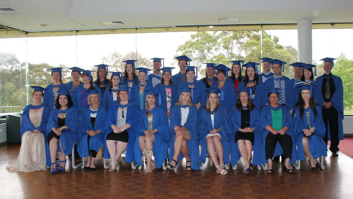 University of Wollongong Bega campus graduands gather for an official photograph before the 2013 graduation ceremony held at the Pambula-Merimbula Golf Club on Monday.