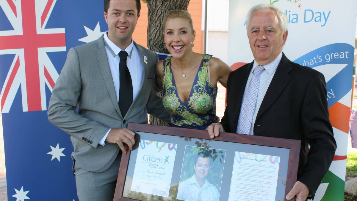 Bega Valley Shire Citizen of the Year Ryan Campbell is presented with his award by Australia Day Ambassador Catriona Rowntree and Mayor Bill Taylor.