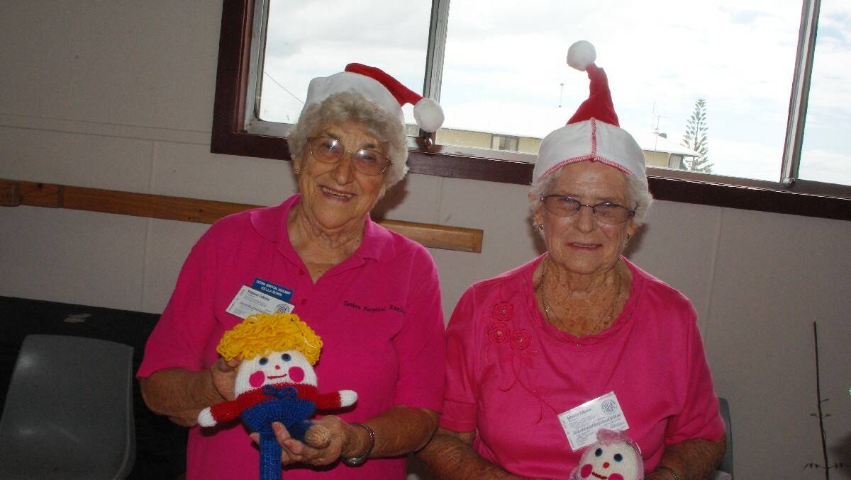 Nella Bown and Olga McAppion with knitted dolls on the arts and craft stall at Tathra Hall.