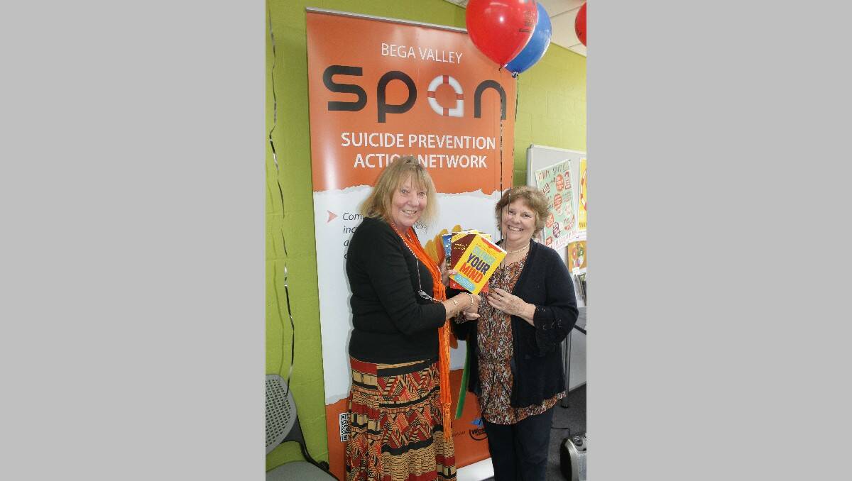 Councillor and Bega Valley Suicide Prevention Action Network representative Liz Seckold (left) presents a series of mental health-related books to Bega library’s Ros Raward.