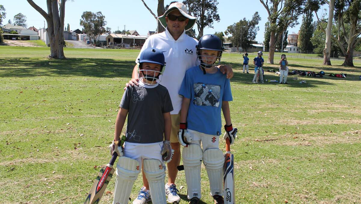 Monarch Cricket Academy founder Mark Higgs meets Bega Valley junior cricketers Tom Walker (left) and Otis Coyle on Friday morning.