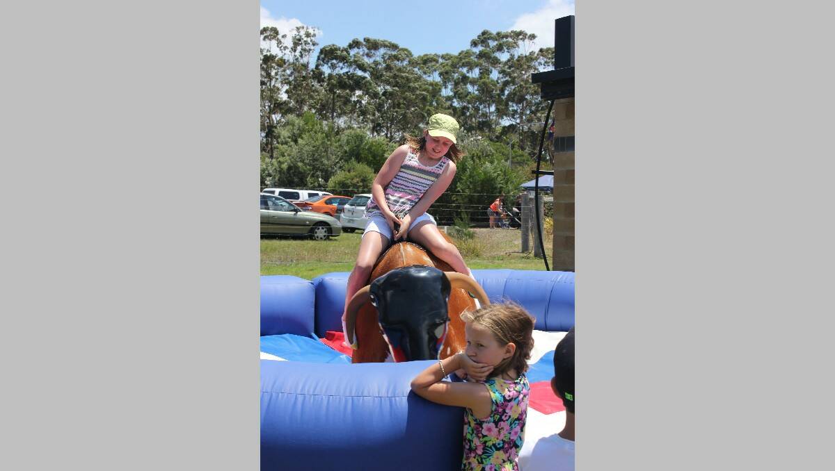Sophie O’Meara shows her skills on the mechanical bull at the Sapphire Coast Turf Club. 