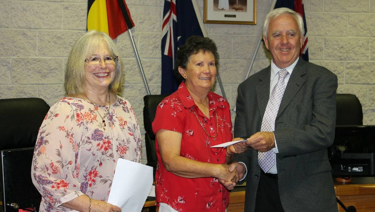 Carol Russell (centre) accepts a Mumbulla Foundation cheque on behalf of the Accommodation Parent Support Group from Olwen Morris (left) and Bill Taylor.
