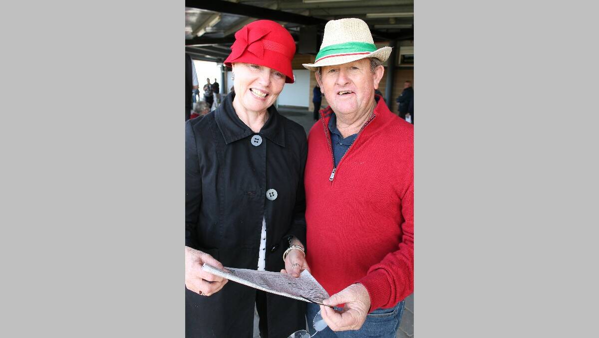 Canberra visitors Cheryll Bowyer and Garry Gumm study their form guide at Sunday’s race meeting.